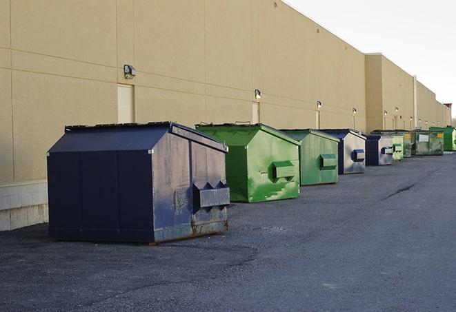 construction dumpsters on a worksite surrounded by caution tape in Dorchester